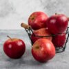 Ripe organic red apples in metal basket on black background GRANNY SMITH APPLE