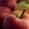Selective focus shot of red apples placed on the table GRANNY SMITH APPLE
